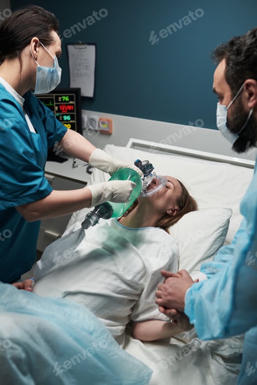 Preview: Caucasian Middle Aged Woman Receiving Oxygen Support from Medical Team in Hospital