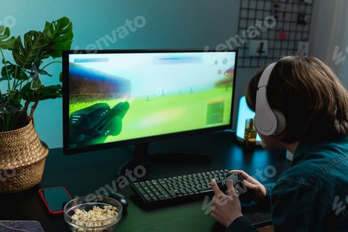 Preview: Young girl gamer playing video shooting game online - Technology trend concept