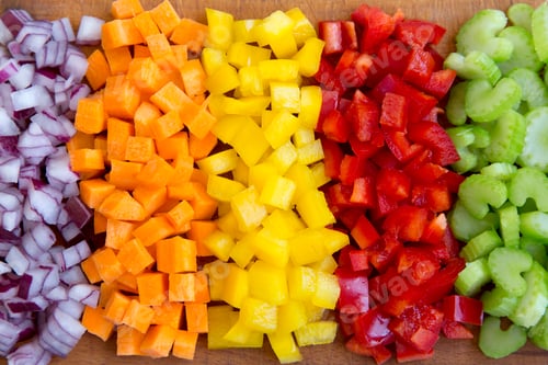 Preview: Chopped fresh vegetables (carrot, celery, red onion, peppers) arranged on cutting board