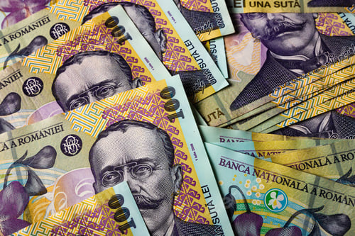 Preview: Closeup of the Romanian LEI bill pile spread on a table