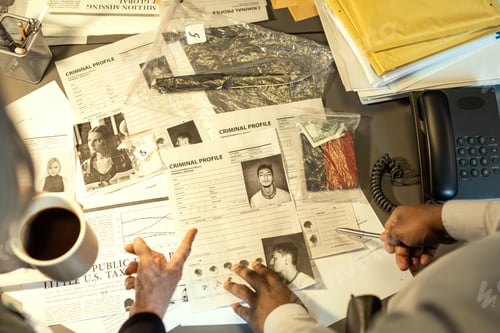 Preview: Hands of two interracial FBI agents pointing at profile killer or bandit