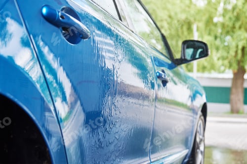Preview: Cleaning car with high pressure water at car wash station