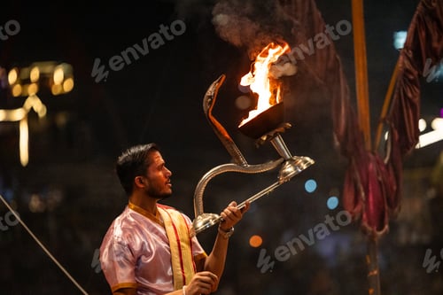 Preview: Hindu priest holding a burning aarti during Ganga aarti ceremony in Varanasi