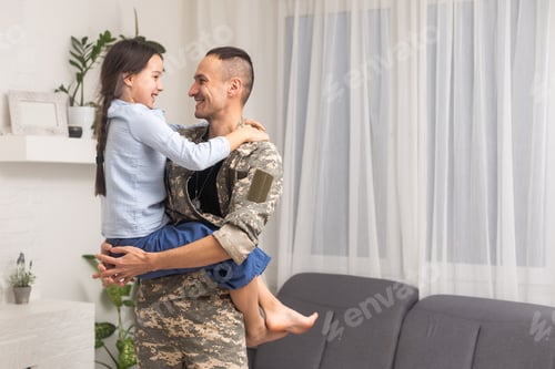 Preview: military father hugging his daughter.