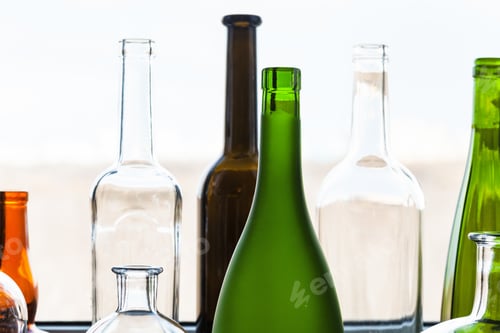 Preview: various empty bottles near window at home
