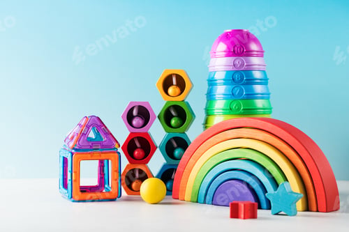 Preview: Contemporary toys to play and develop for toddlers on blue background closeup