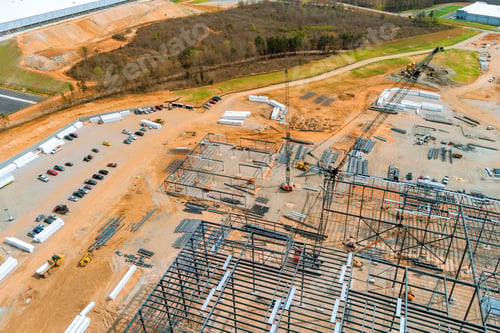 Preview: New industrial facility under construction with extensive groundwork steel framework visible
