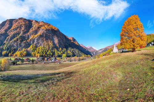 Preview: Astonishing autumn landscape at Heiligenblut with St Vincent Church near Grossglockner mount .