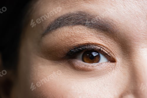 Preview: partial view of asian woman looking at camera, eye care concept
