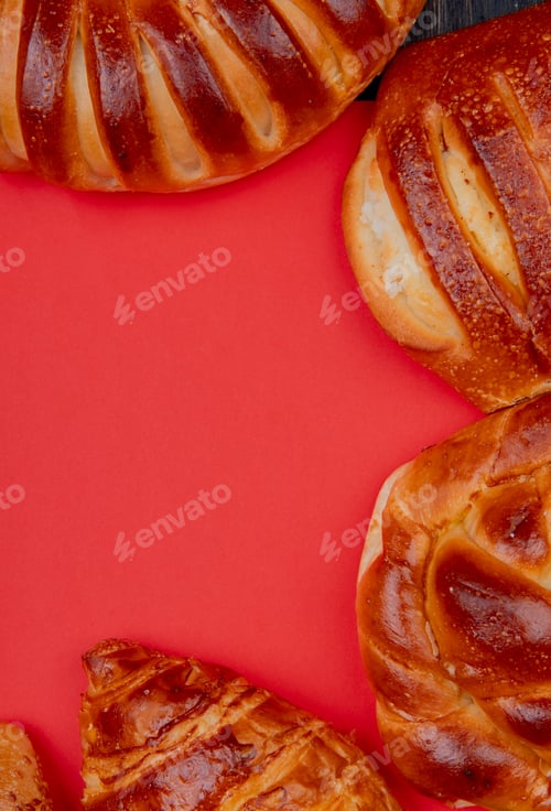 Preview: top view of different bakery products set in round shape on red background with copy space