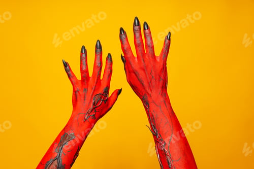 Preview: Creepy, red hands of a monster on a yellow background