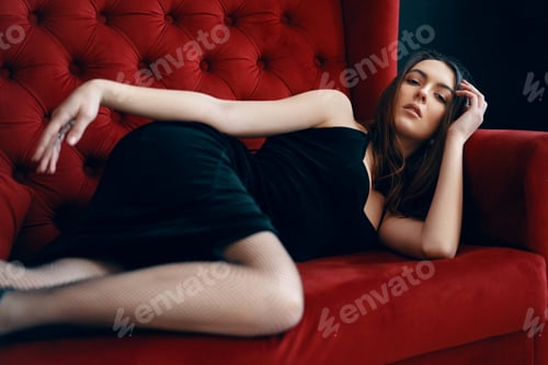 Preview: Woman Lying on Red Velvet Couch