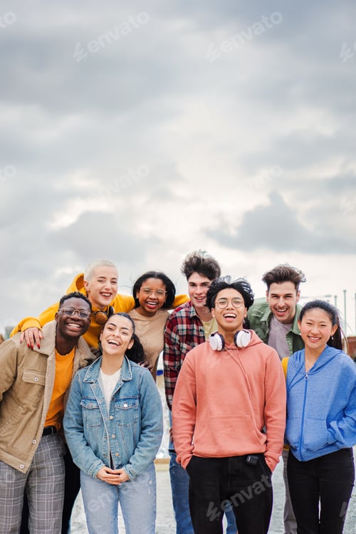Preview: Vertical portrait of a big goup of multiracial teenage highschool students having fun,smiling and