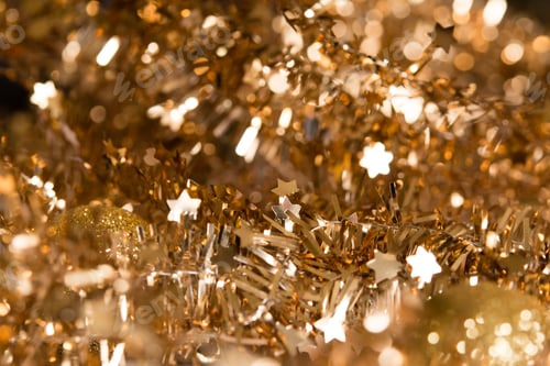 Preview: Beautiful abstract shiny gold light background, garland with stars and bokeh