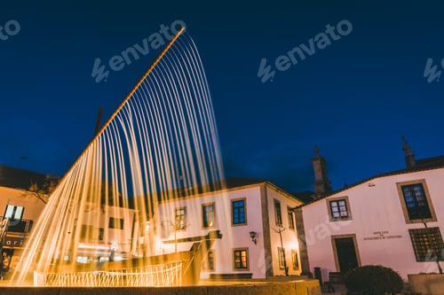 Preview: Beautiful shot of a water fountain near buildings at night tie in Esposende, Portugal