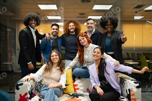 Preview: Joyful team celebrating success in office.