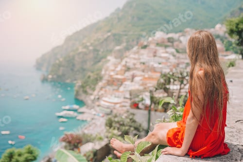 Preview: Adorable little girl on warm and sunny summer day in Positano town in Italy