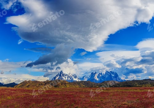 Preview: Majestic Mountain Range with Vibrant Field, Cloudy Sky