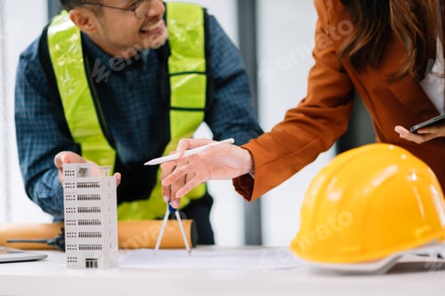 Preview: Two colleagues discussing data working and tablet, laptop with on architectural project