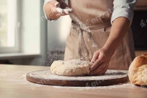 Preview: Female baker preparing bread dough at table, closeup
