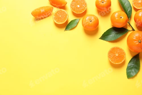 Preview: Fresh tangerines and leaves on color background, flat lay with space for text. Citrus fruits