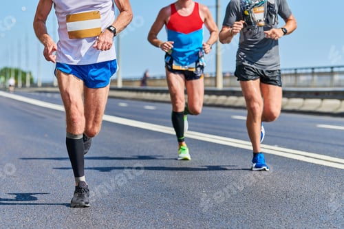 Preview: Marathon runners on city road.
