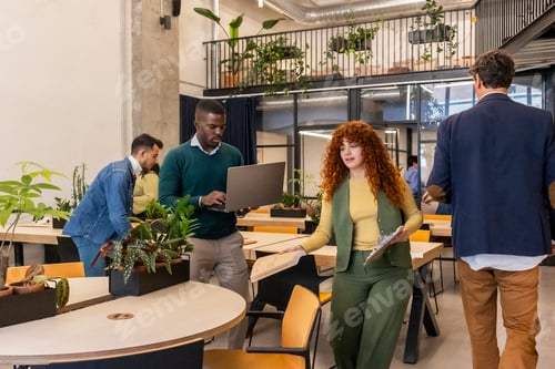 Preview: Diverse business professionals collaborating in modern coworking office
