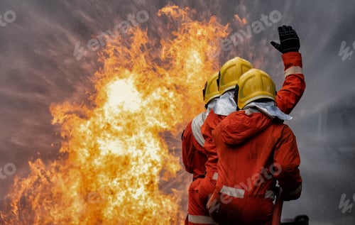 Preview: fire fighter team on training with gas and oil fire hold hose spray jet water spray to extinguish