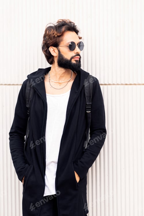 Preview: Man in Black Hoodie Leaning Against White Wall