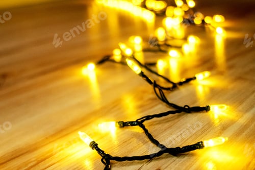 Preview: Garland glowing with warm light on floor. The atmosphere of the Christmas holidays.