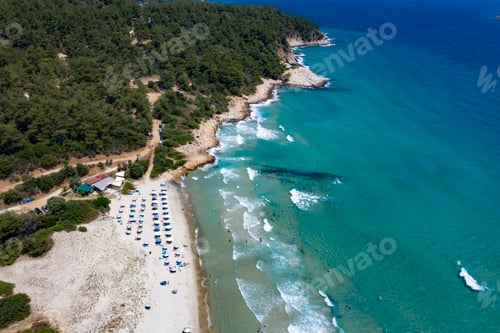 Preview: Thassos seaside beach with turquoise water and big waves aerial view.