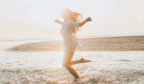 Preview: slim beautiful woman in white cotton dress walking on tropical beach