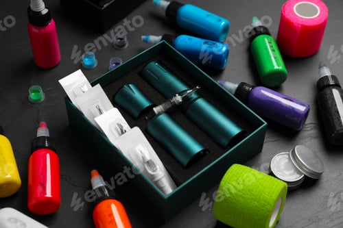 Preview: Professional tattoo equipment on black table, closeup