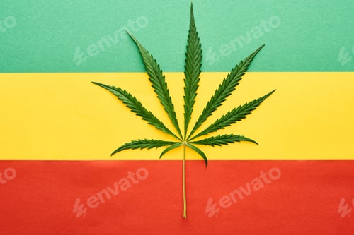 Preview: top view of cannabis leaf on Rastafarian flag background