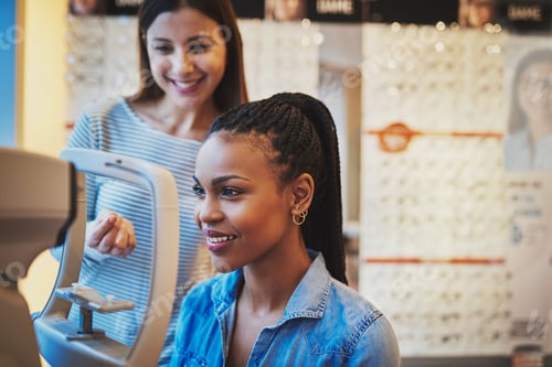 Preview: Smiling young black woman ready to take eye exam