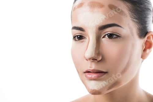 Preview: beautiful girl with foundation cream on face looking away isolated on white