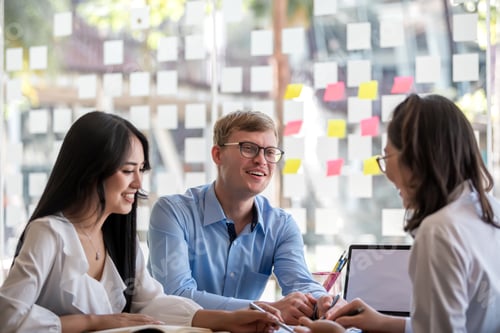 Preview: Group of young modern people in smart casual wear at meeting together to analyze