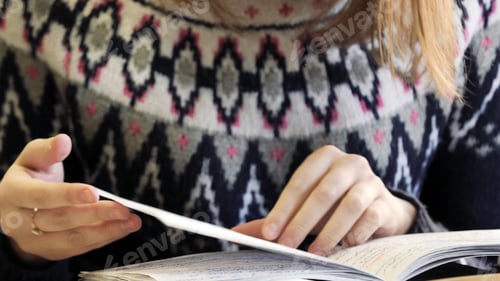 Preview: Close-up of paper book, notebook, diary on table in university. Girl leafing through notebook. Girl