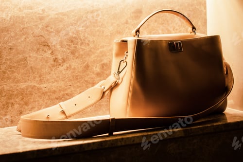 Preview: Woman’s beige handbag on marble. Fashion blog concept. Copy space