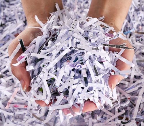 Preview: Studio shot of a womans hands holding a pile of shredded paper