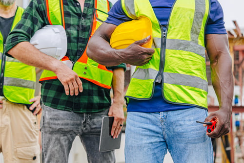Preview: Closeup workers teamwork service man in construction industrial. Diverse workers