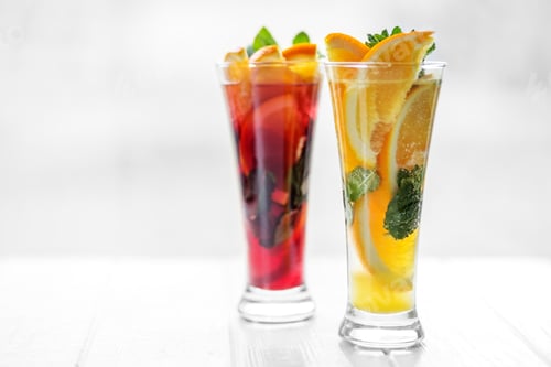 Preview: Refreshing healthy cocktails with mint and citrus and pomegranate on a white background.