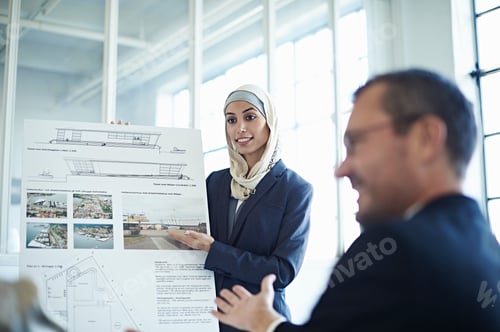 Preview: Young businesswoman presenting ideas to businessman in office