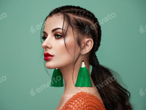 Woman with Braided Hair and Dramatic Green Earrings