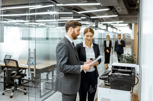 Preview: Business people near the copier in the hallway
