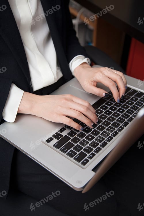 Preview: Businesswoman working on laptop