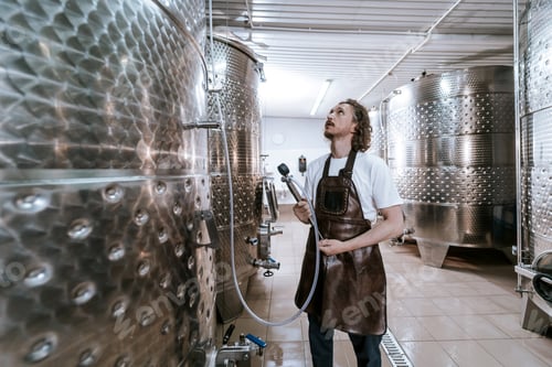 Preview: Modern winery with metal barrels.