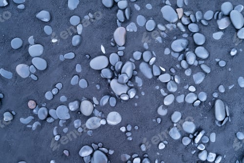 Preview: Black sand and pebble as a background. Round stones on the beach.