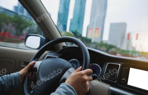 Preview: People hands holding steering wheel while driving car on city road