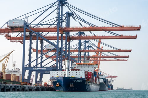 Preview: crane loading cargo container from truck to container ship in the international terminal logistic